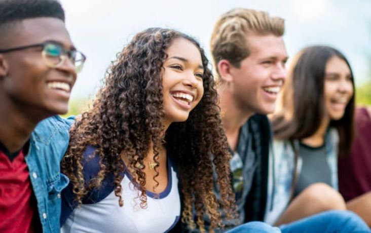Giving teens condoms mixed group or youth laughing