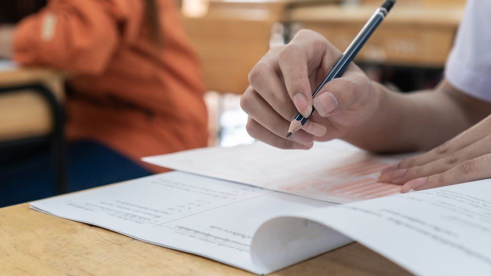 matric results holding pen in hand