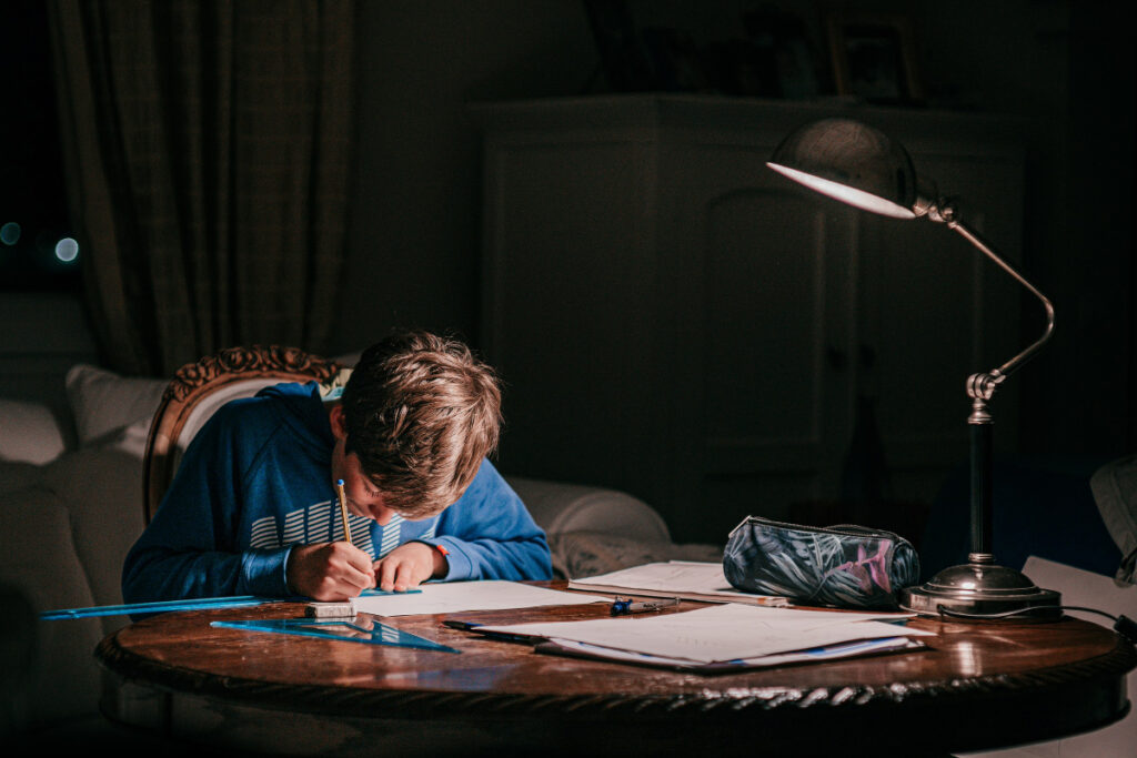 homework tasks boy working in dark