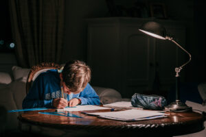 homework tasks boy working in dark