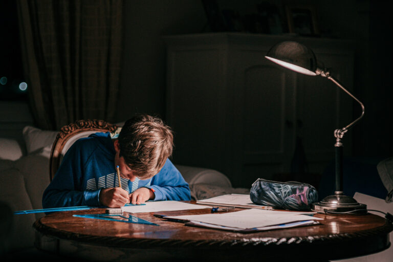 homework tasks boy working in dark