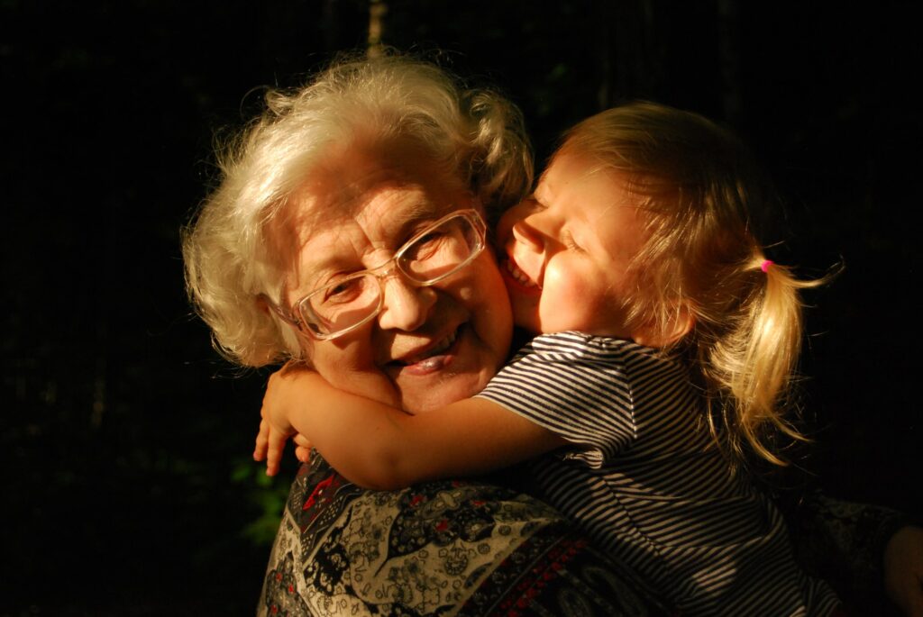 grandparent's love child hugs grandma